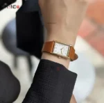 ساعت دنیل ولینگتون مدل DW00100696 طلایی با بند قهوه ای روی دست
